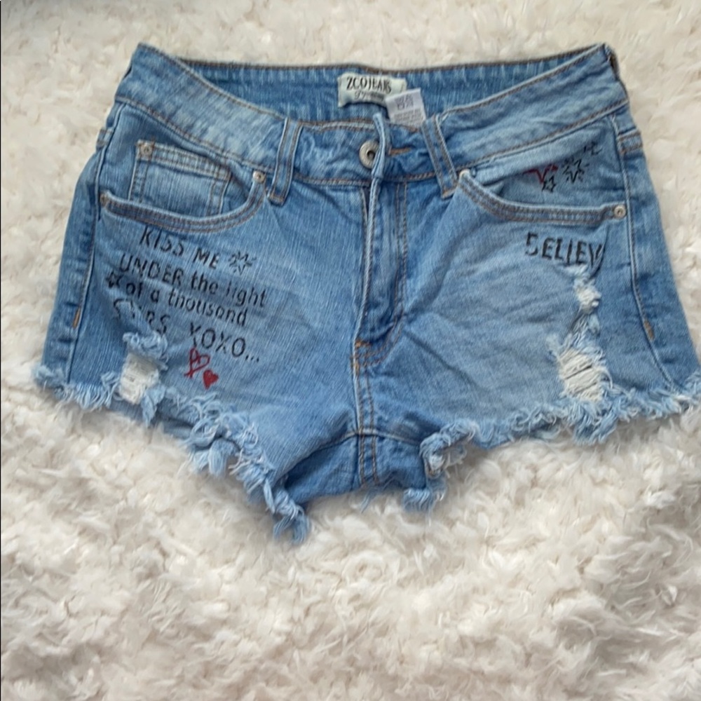 jean shorts with writing.